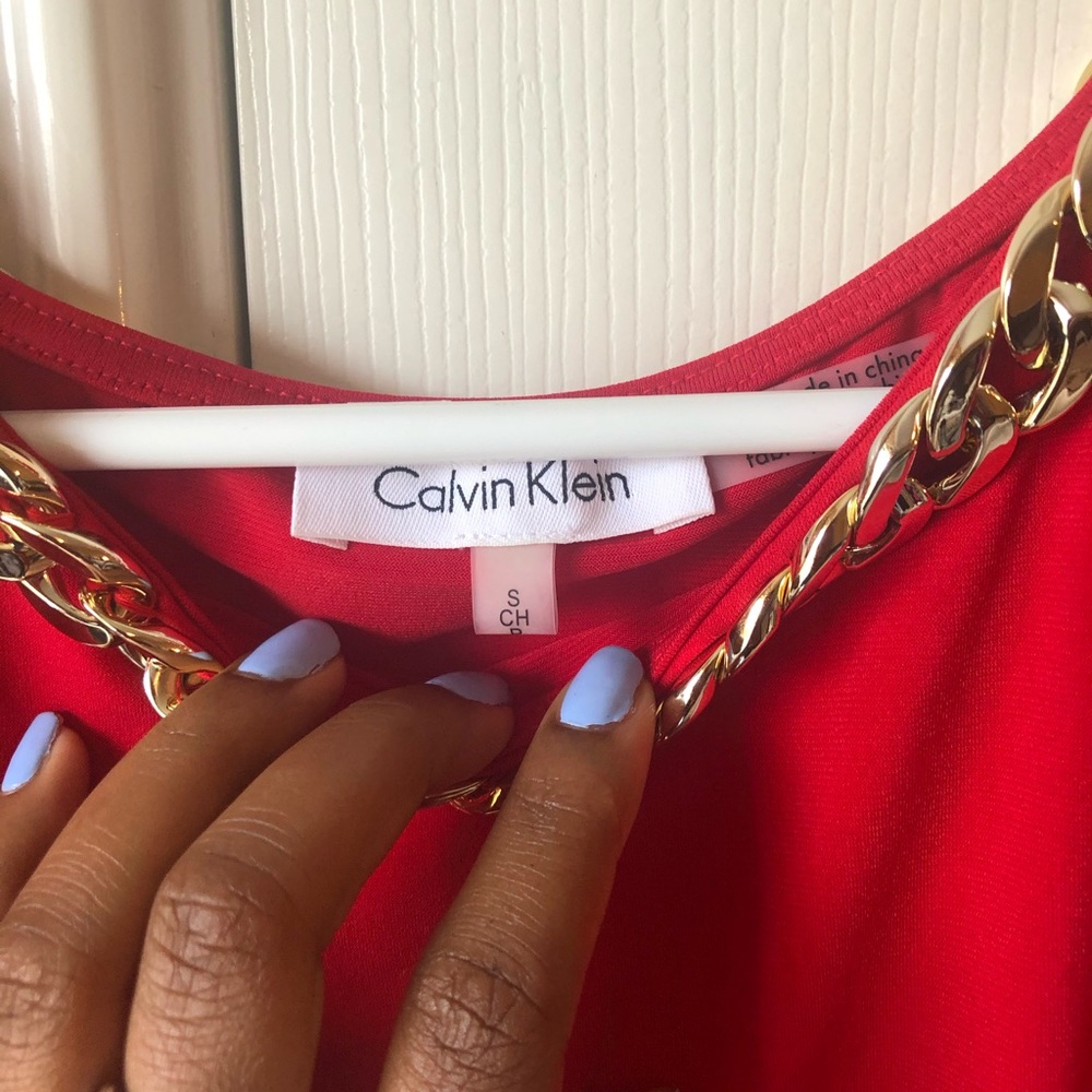 Red Calvin Klein with gold accents